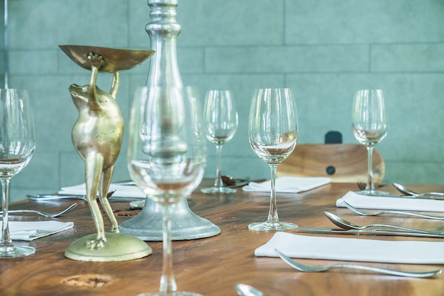 A dinner table set with coordinated crystal stemware and a centrepiece