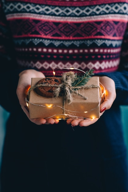 A crystal gift being wrapped in seasonal cloth with a handwritten card