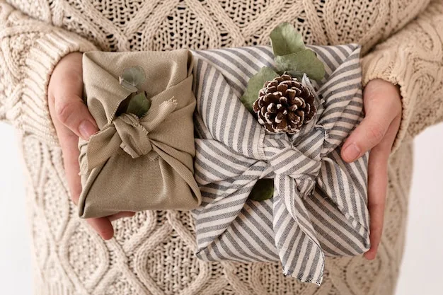 A crystal gift wrapped in seasonal cloth with a handwritten card