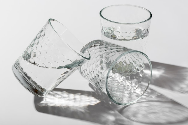 A technician examining a clouded crystal glass near natural light